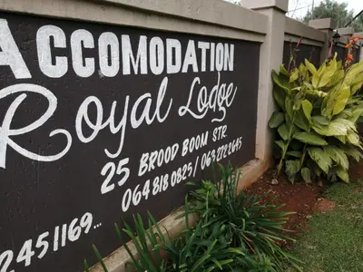 a sign for a local cafe on a building at Royal guest lodge in Middelburg