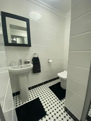 a white bathroom with a sink and a toilet at Sleep on 489 in Pretoria