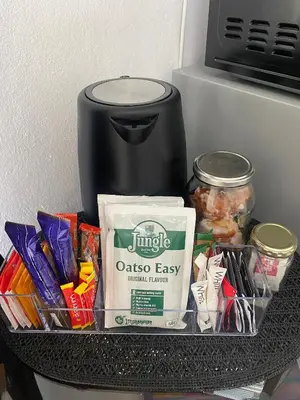 a shelf with snacks and a container of food at Sleep on 489 in Pretoria