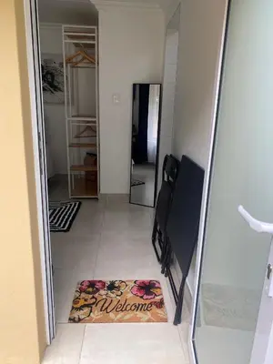 a room with a mirror and a rug on the floor at Sleep on 489 in Pretoria