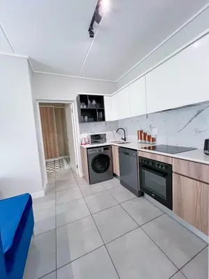 a kitchen with a stove and a dishwasher at Ls apartment in Midrand