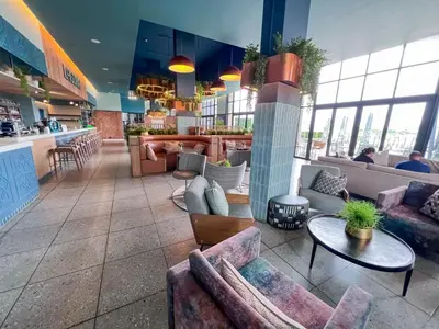 a lobby with couches and tables in a restaurant at Ls apartment in Midrand