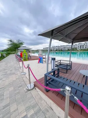 a deck with a bench and a playground next to the water at Ls apartment in Midrand
