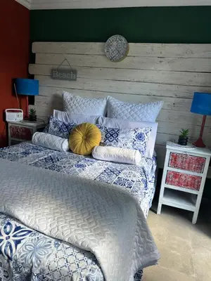 a bed with pillows on it in a bedroom at Tiny harties in Hartbeespoort