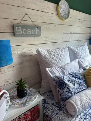a room with a couch and a table with pillows at Tiny harties in Hartbeespoort