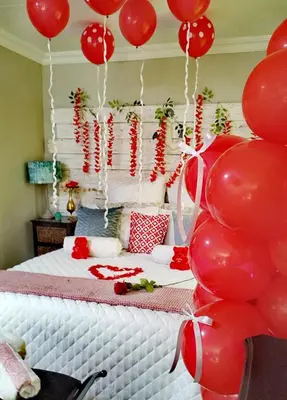 a room with a bed with red balloons on it at Tiny harties in Hartbeespoort