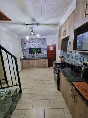 a large kitchen with a stove and a counter top at Mediterranean Palms in Pretoria
