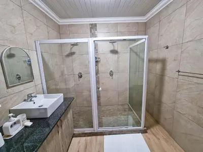 a bathroom with a shower and a sink at Mediterranean Palms in Pretoria