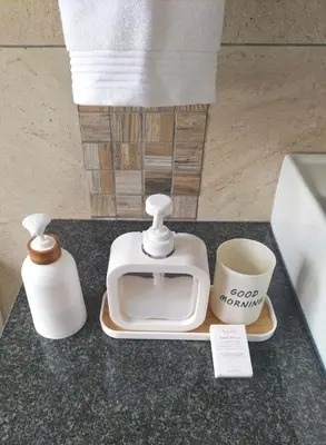 a counter top with a toaster and a cup of coffee at Mediterranean Palms in Pretoria