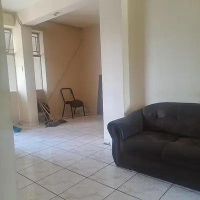 a living room with a couch sitting on a tile floor at The mighty Sleep in Pretoria