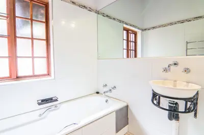 a bathroom with a sink and a mirror at Private room with en-suite bathroom in Pretoria