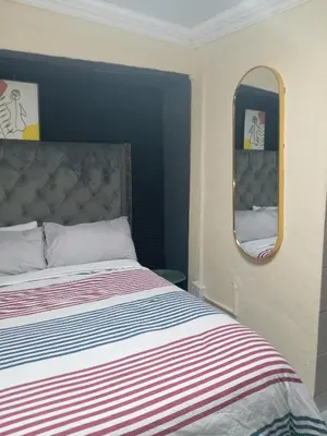 a bedroom with a bed and a mirror at Comfort Place 4 in Pretoria