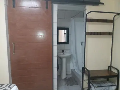 a bathroom with a toilet and a sink and a door at Comfort Place 4 in Pretoria