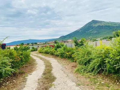 a dirt road with bushes and a mountain in the background at Morning Star Guest House & Lodge in Burgersfort