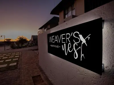 a sign on the side of a building at Weavers Nest Guesthouse in Modimolle