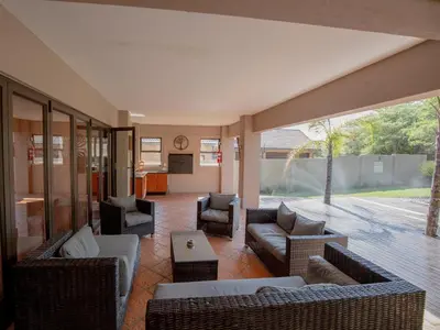 a large living room with couches and chairs at Weavers Nest Guesthouse in Modimolle
