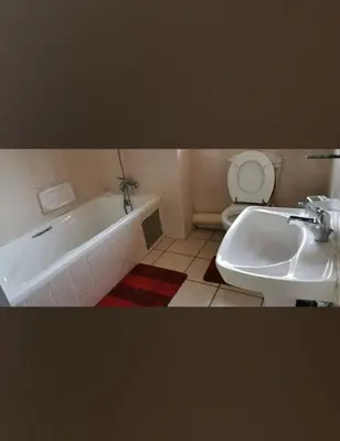 a bathroom with a tub and a toilet and a sink at Charming Tshwane BB with Secure Entrance Central AC in Pretoria