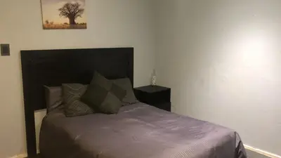 a bedroom with a bed and a picture on the wall at The Chardonay Inn in Centurion