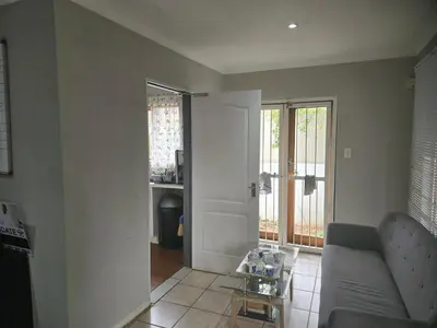 a living room with a couch and a table at The Chardonay Inn in Centurion