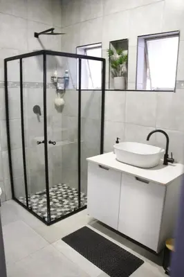 a bathroom with a shower and a sink at Aeon Guest House & Spa in Pretoria