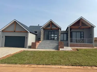 a large house with a garage at The Gorge View at Highland Gate in Dullstroom