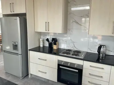 a kitchen with a stove and a refrigerator at The Gorge View at Highland Gate in Dullstroom