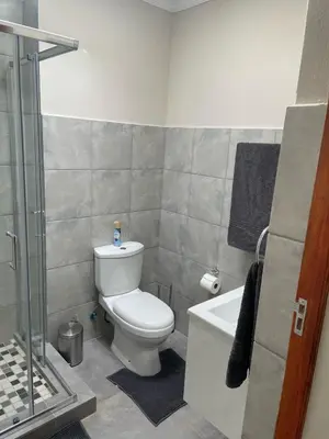 a bathroom with a toilet and a sink and a shower at The Gorge View at Highland Gate in Dullstroom