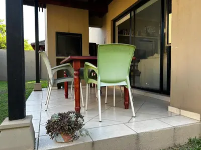 a table and chairs sitting on a patio at Kingfisher's Song in Nelspruit