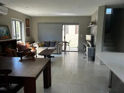 a living room with a couch and a table at Kingfisher's Song in Nelspruit