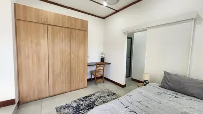 a bedroom with a large wooden closet and a desk at Exclusive Stay in Secure Estate in Pretoria