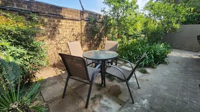 a small table and two chairs on a patio at Exclusive Stay in Secure Estate in Pretoria