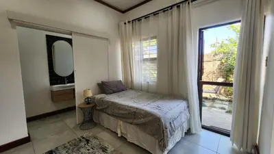 a bedroom with a bed and a large window at Exclusive Stay in Secure Estate in Pretoria