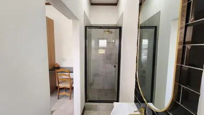 a bathroom with a shower and a mirror at Exclusive Stay in Secure Estate in Pretoria