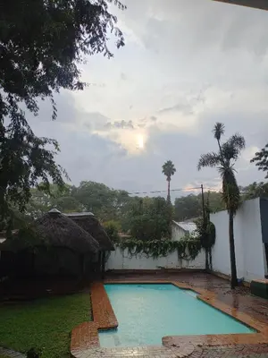 a swimming pool in the yard of a house at Avenue luxury home in Pretoria