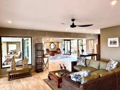 a living room with a couch and a table at Elephant Walk Tented Camp in Komatipoort