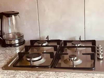 a stove top with four burners on a kitchen counter at Capricon Village 3 Bedroom Villa in Centurion