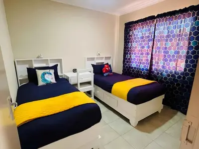 a bedroom with two beds and a window at Capricon Village 3 Bedroom Villa in Centurion