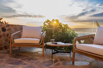 two chairs and a coffee table on a patio at Enso Botanico Boutique Villa, Kosmos in Hartbeespoort