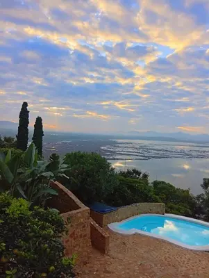 a swimming pool with a view of the ocean at Enso Botanico Boutique Wellness Villa, with an outside wood-fire Hot Tub in Kosmos in Hartbeespoort