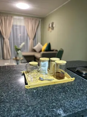 a tray of glasses on a counter in a living room at Olive view Retreat in Midrand