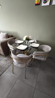a table with two chairs and a table with wine glasses at Olive view Retreat in Midrand