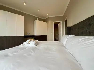 a large white bed in a bedroom at Deluxe fully furnished apartment in Menlyn Maine residence 1209 in Pretoria
