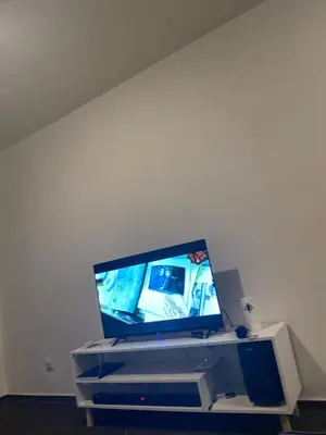 a flat screen tv sitting on top of a stand at Kim in Pretoria
