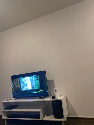 a flat screen tv sitting on top of a entertainment center at Kim in Pretoria
