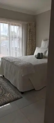 a white bed in a bedroom with a window at Ee40Yethu in Pretoria
