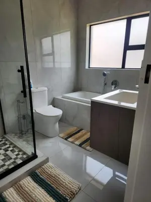 a bathroom with a tub and a toilet and a sink at Ee40Yethu in Pretoria