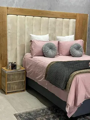 a bedroom with a bed with pink pillows at Kruger Place in Mokopane