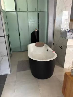 a bathroom with a bath tub with a towel on it at Kruger Place in Mokopane
