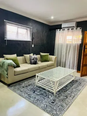 a living room with a couch and a coffee table at Kruger Place in Mokopane