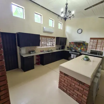 a large kitchen with a island in the middle at Six Senses in Marloth Park